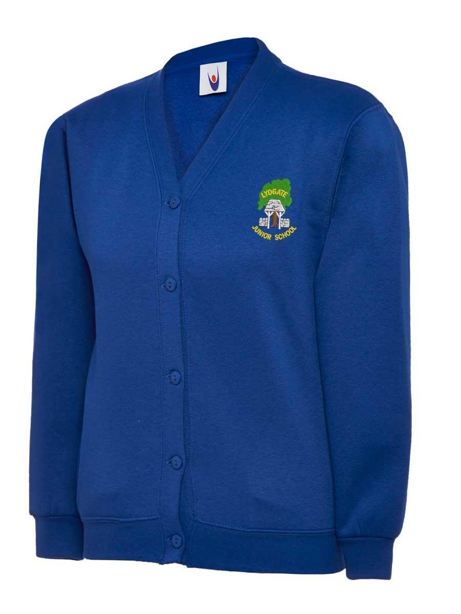 Blue cardigan with long sleeves and a button-down front. It features an embroidered school logo on the upper left side, depicting a tree and a book with text above and below. The cardigan is displayed against a plain white background.