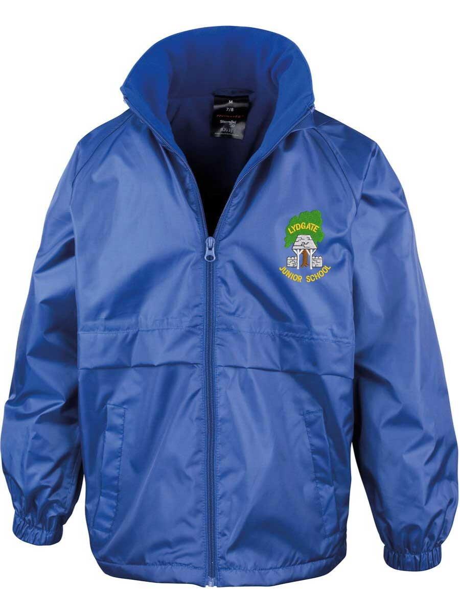A blue jacket with a zippered front and two side pockets. The jacket features a logo with text and a design on the left chest area. The collar is raised, and the cuffs are elastic. The background is plain white.