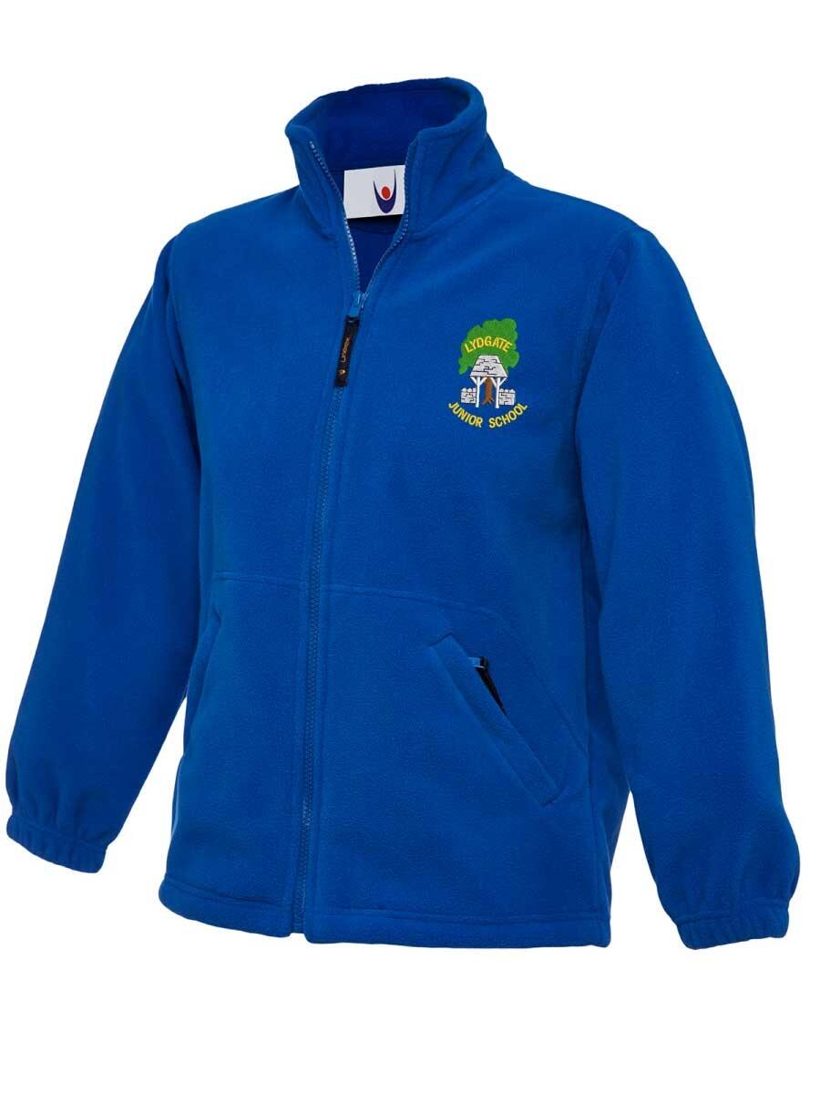 Blue fleece jacket with a high collar, front zipper, and two pockets. The left chest features an embroidered emblem with text, depicting a tree and book design. The jacket appears to be made of soft, warm material.