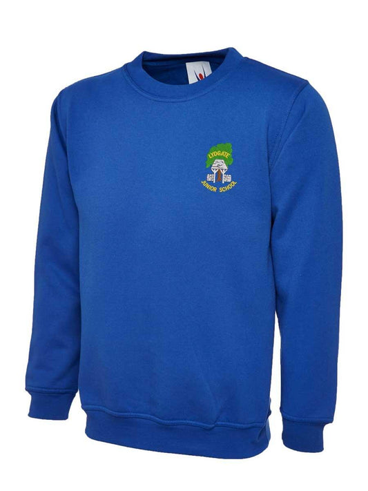 A blue sweatshirt with a small embroidered logo featuring a crest and text on the left chest area. The sweatshirt has long sleeves and a round neckline.