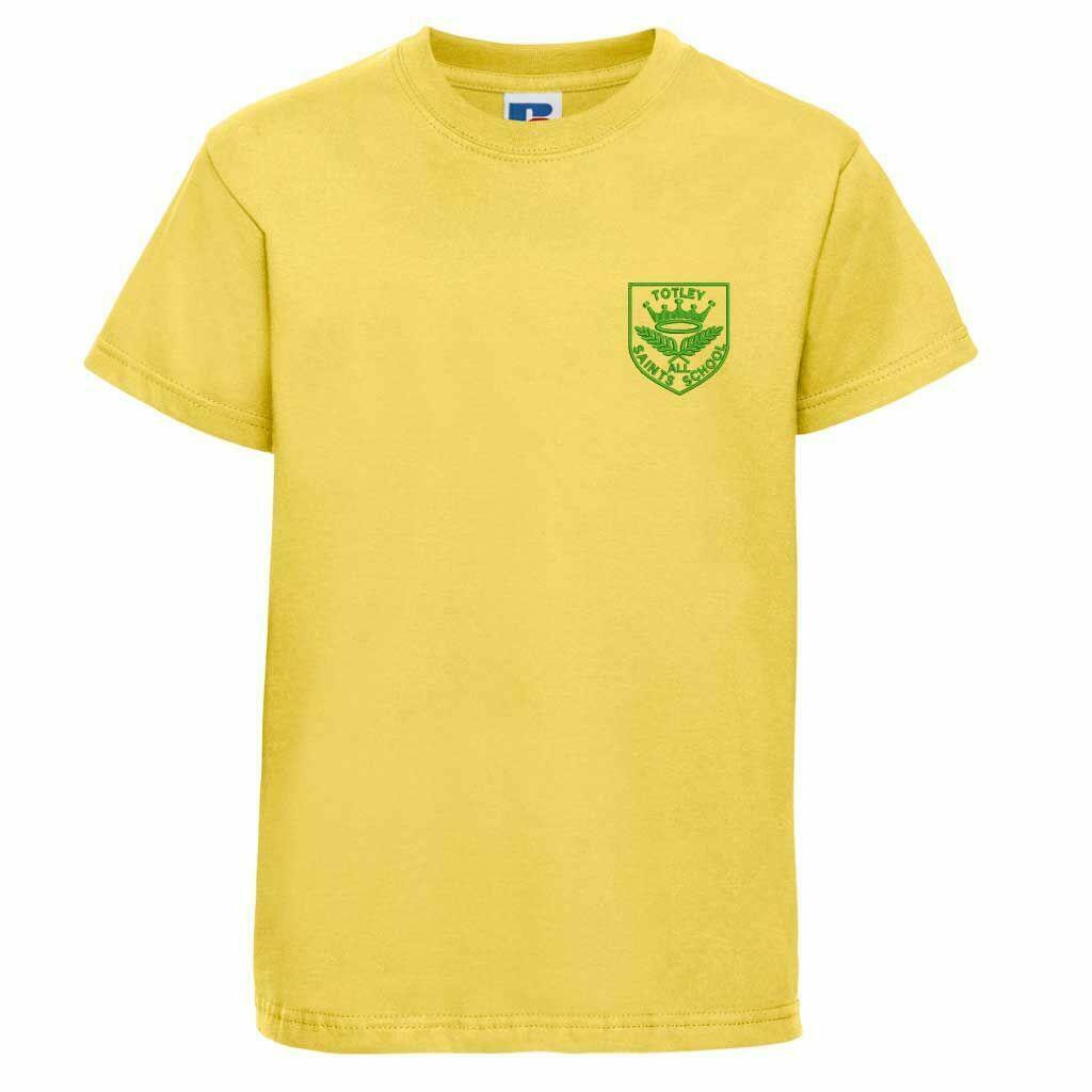 A plain yellow T-shirt with short sleeves featuring a small green emblem on the upper left chest. The emblem includes a crown and the text "Totley All Saints."